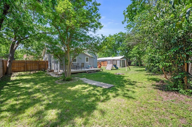 1503 Hart St, Georgetown, TX 78626 - fenced backyard with a deck and an outbuilding