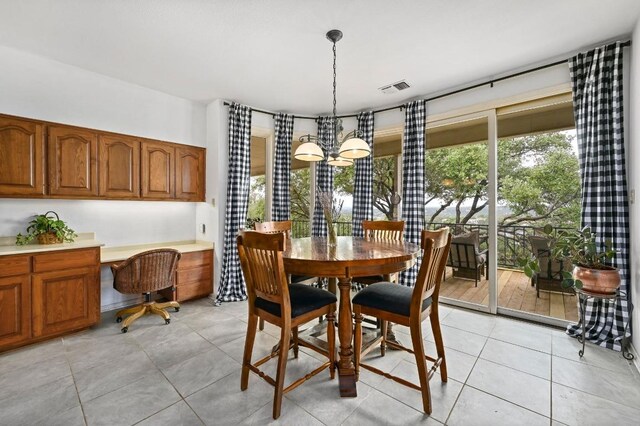 3225 Eisenhower Ave, Lago Vista, TX 78645 - dining room featuring light tile patterned flooring and a chandelier