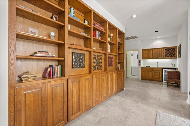 3225 Eisenhower Ave, Lago Vista, TX 78645 - hall featuring light tile patterned floors, wine cooler, and a sink