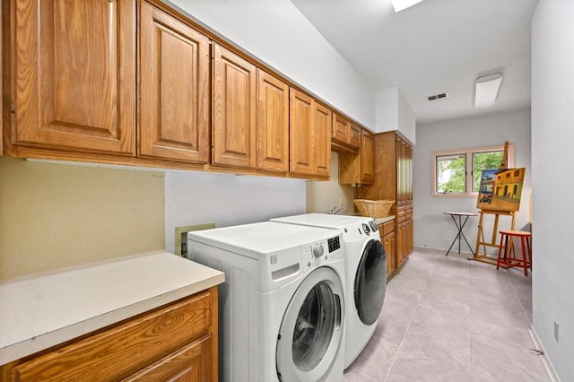 3225 Eisenhower Ave, Lago Vista, TX 78645 - washroom featuring cabinet space, washing machine and dryer, light tile patterned floors, and baseboards