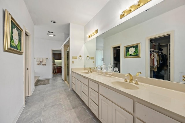 3225 Eisenhower Ave, Lago Vista, TX 78645 - full bathroom featuring double vanity, a walk in closet, and tile patterned floors