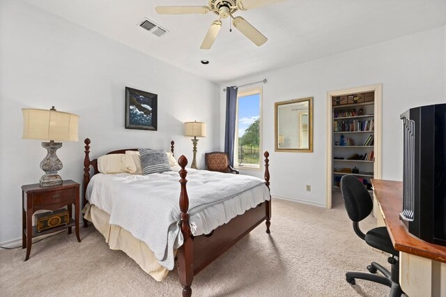 3225 Eisenhower Ave, Lago Vista, TX 78645 - bedroom with light colored carpet, ceiling fan, and baseboards