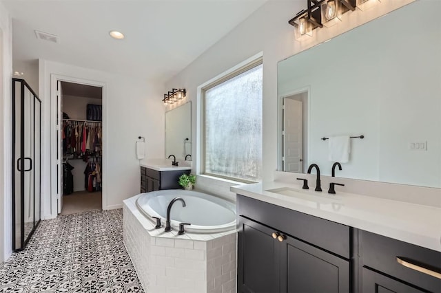 1205 Bluewood Bnd, Leander, TX 78641 - bathroom with two vanities, a garden tub, a stall shower, and recessed lighting