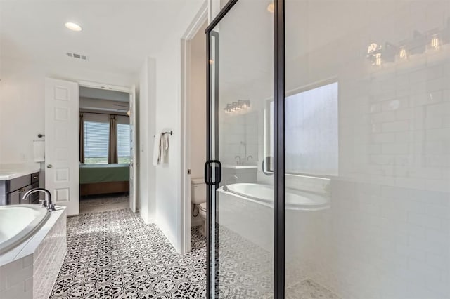 1205 Bluewood Bnd, Leander, TX 78641 - full bath with connected bathroom, a stall shower, a garden tub, vanity, and toilet