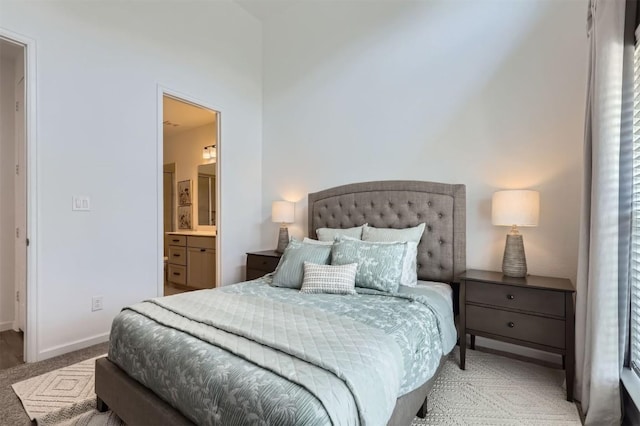 1205 Bluewood Bnd, Leander, TX 78641 - bedroom featuring carpet floors, baseboards, and ensuite bath