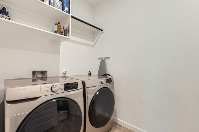 1205 Bluewood Bnd, Leander, TX 78641 - laundry room featuring separate washer and dryer and baseboards