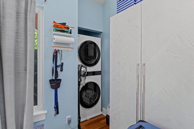 504 E 38th 1/2 St, Austin, TX 78751 - laundry room featuring stacked washing machine and dryer and wood finished floors