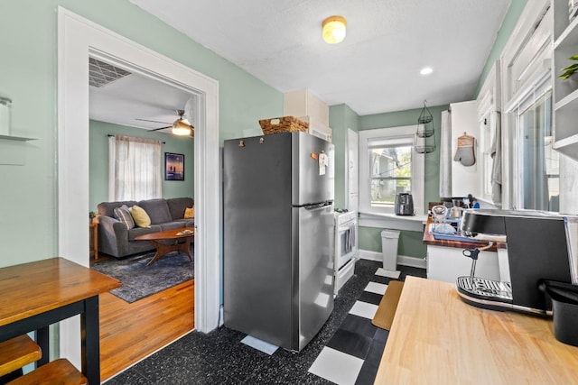 504 E 38th 1/2 St, Austin, TX 78751 - kitchen with freestanding refrigerator, a ceiling fan, and baseboards