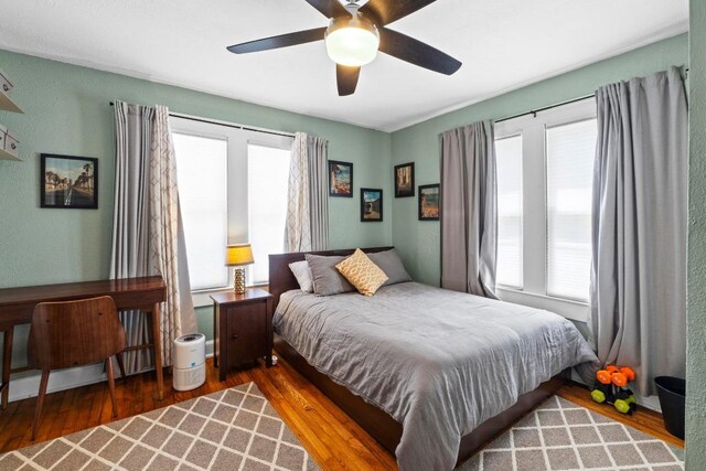 504 E 38th 1/2 St, Austin, TX 78751 - bedroom featuring multiple windows, wood finished floors, and ceiling fan