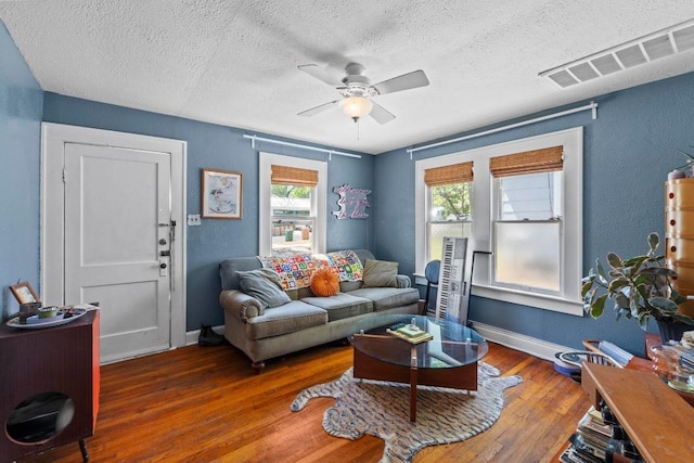 504 E 38th 1/2 St, Austin, TX 78751 - living room featuring a textured ceiling, wood-type flooring, ceiling fan, baseboards, and a textured wall