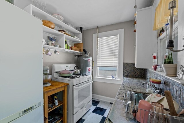 504 E 38th 1/2 St, Austin, TX 78751 - kitchen with white appliances, light flooring, baseboards, decorative backsplash, and water heater