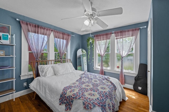 504 E 38th 1/2 St, Austin, TX 78751 - bedroom featuring baseboards, wood finished floors, a textured ceiling, and ceiling fan