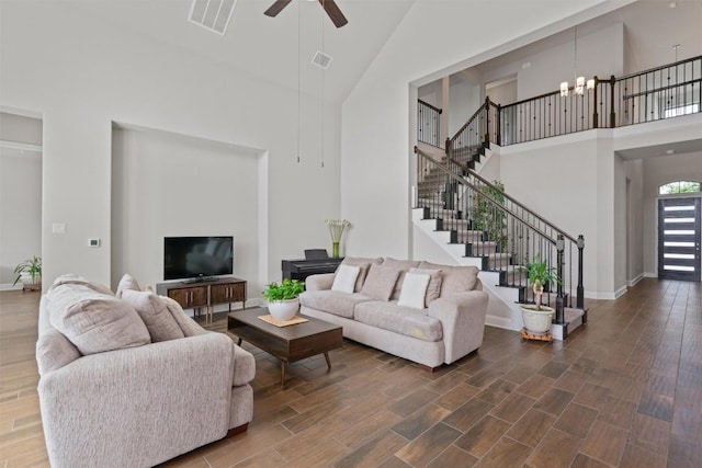 3912 Logan Ridge Dr, Cedar Park, TX 78613 - living room with stairway, visible vents, ceiling fan with notable chandelier, and a towering ceiling