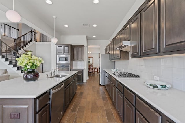 3912 Logan Ridge Dr, Cedar Park, TX 78613 - kitchen featuring dark brown cabinetry, visible vents, appliances with stainless steel finishes, a sink, and light countertops