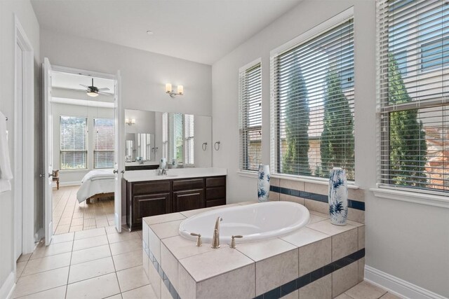 3912 Logan Ridge Dr, Cedar Park, TX 78613 - bathroom featuring a garden tub, vanity, baseboards, tile patterned floors, and ensuite bath