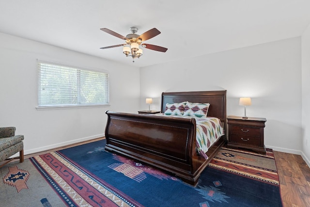 bedroom with wood finished floors, baseboards, and a ceiling fan