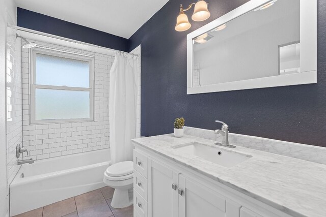 full bath with toilet, tile patterned floors, shower / tub combo with curtain, and vanity