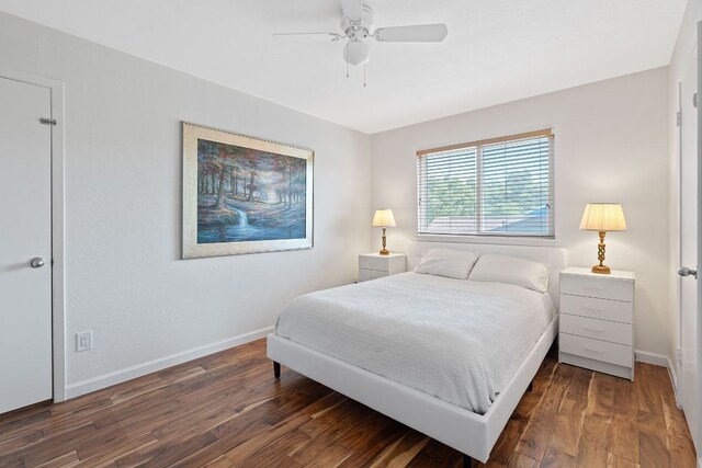 bedroom featuring baseboards, wood finished floors, and ceiling fan