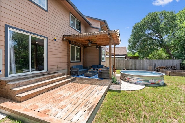 wooden terrace featuring an outdoor hangout area, ceiling fan, a jacuzzi, and entry steps