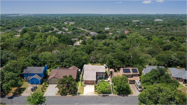 aerial view of residential area with property parcel outlined and a forest
