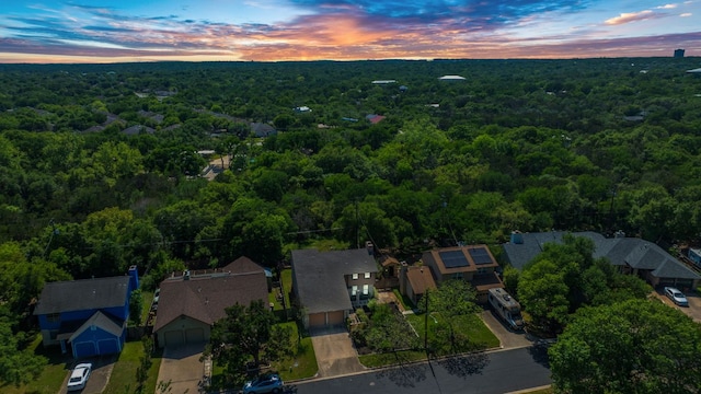 aerial view at dusk of a view of trees and a residential view