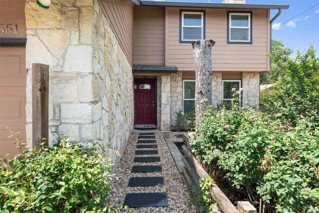 property entrance with stone siding