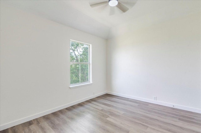 spare room with light wood-style floors, baseboards, and ceiling fan