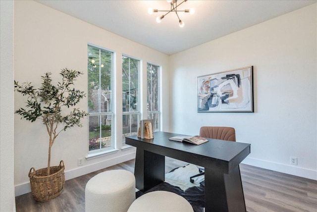 office featuring baseboards, wood finished floors, and a chandelier