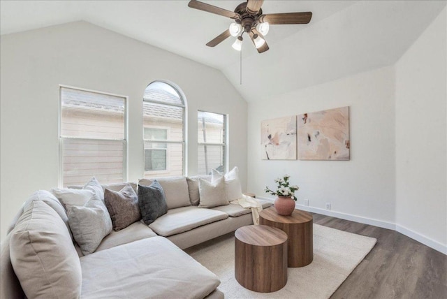 living area with vaulted ceiling, a ceiling fan, wood finished floors, and baseboards