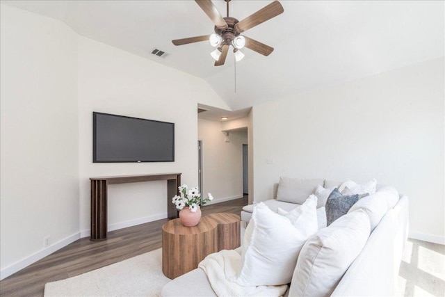 living area with a ceiling fan, wood finished floors, baseboards, lofted ceiling, and visible vents