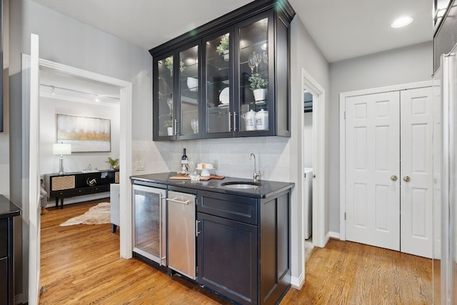 1006 Gaston Ave, Austin, TX 78703 - bar featuring tasteful backsplash, light wood-style flooring, a sink, beverage cooler, and wet bar