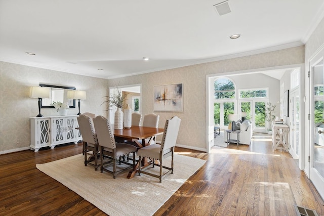 1006 Gaston Ave, Austin, TX 78703 - dining space featuring wood finished floors, wallpapered walls, baseboards, visible vents, and crown molding