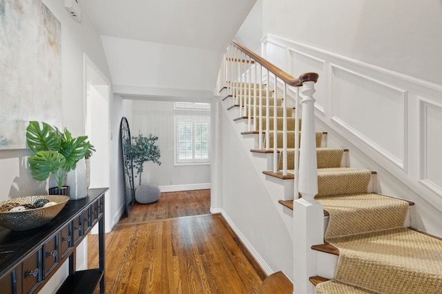 1006 Gaston Ave, Austin, TX 78703 - stairs with baseboards and wood finished floors