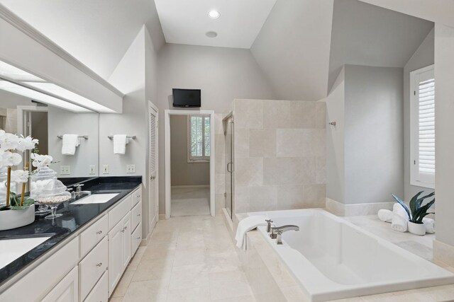 1006 Gaston Ave, Austin, TX 78703 - full bathroom featuring lofted ceiling, a sink, double vanity, a stall shower, and a bath