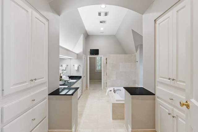 1006 Gaston Ave, Austin, TX 78703 - bathroom with visible vents, tiled shower, a garden tub, and lofted ceiling