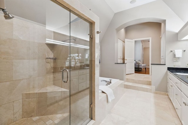1006 Gaston Ave, Austin, TX 78703 - full bath with tile patterned flooring, a shower stall, vaulted ceiling, a bath, and vanity