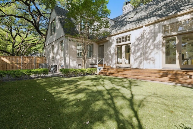 1006 Gaston Ave, Austin, TX 78703 - back of house with a chimney, fence, french doors, and a yard
