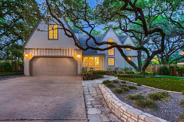 1006 Gaston Ave, Austin, TX 78703 - view of front of property with a front yard, stucco siding, concrete driveway, an attached garage, and fence