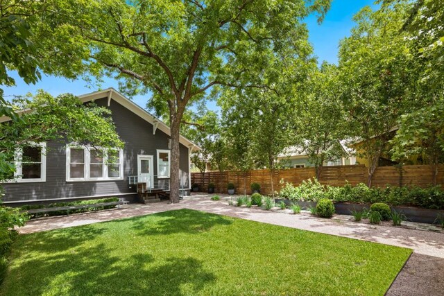 view of yard with fence, a patio area, and entry steps