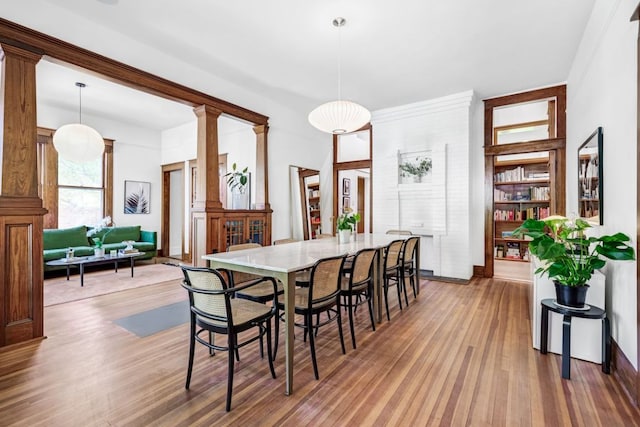 dining area featuring light wood-style flooring and baseboards