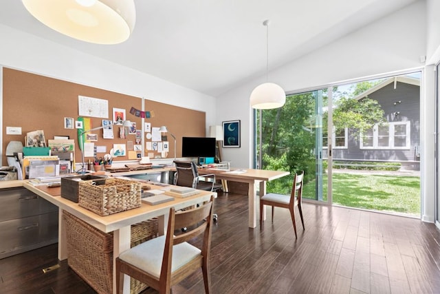 dining space with lofted ceiling and dark wood-type flooring