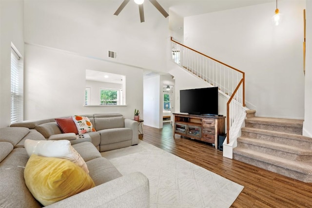 3116 Port Anne Way, Leander, TX 78641 - living area with a ceiling fan, stairway, wood finished floors, a towering ceiling, and baseboards