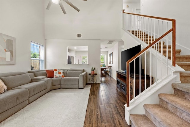 3116 Port Anne Way, Leander, TX 78641 - living area with wood finished floors, ceiling fan, stairs, and a towering ceiling