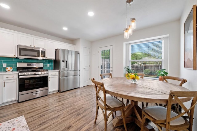 3116 Port Anne Way, Leander, TX 78641 - kitchen with appliances with stainless steel finishes, white cabinets, recessed lighting, decorative backsplash, and light wood-style flooring