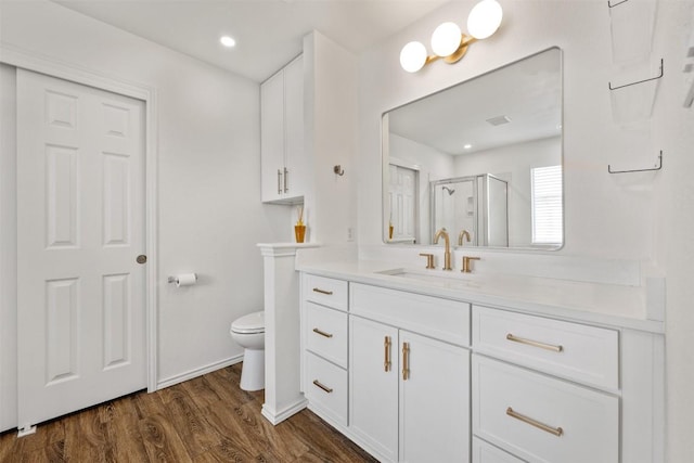 3116 Port Anne Way, Leander, TX 78641 - full bath with toilet, a shower stall, vanity, wood finished floors, and baseboards
