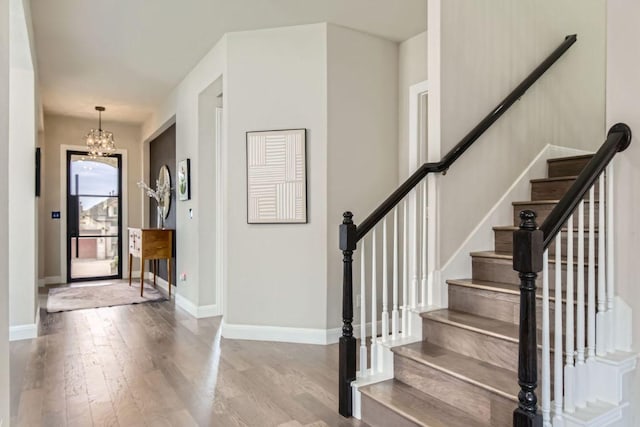 15500 La Catania Way, Austin, TX 78738 - foyer entrance with wood finished floors, a chandelier, baseboards, and stairway