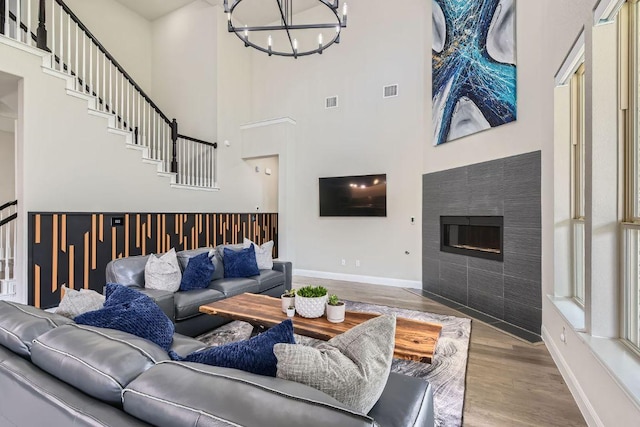 15500 La Catania Way, Austin, TX 78738 - living room with a high ceiling, a chandelier, baseboards, wood finished floors, and stairway