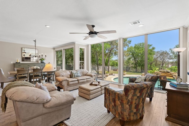2409 Mormon Mill Rd, Marble Falls, TX 78654 - living area with hardwood / wood-style floors, ceiling fan with notable chandelier, expansive windows, visible vents, and recessed lighting