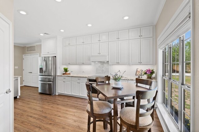 2409 Mormon Mill Rd, Marble Falls, TX 78654 - kitchen with crown molding, tasteful backsplash, stainless steel fridge, white cabinetry, and recessed lighting
