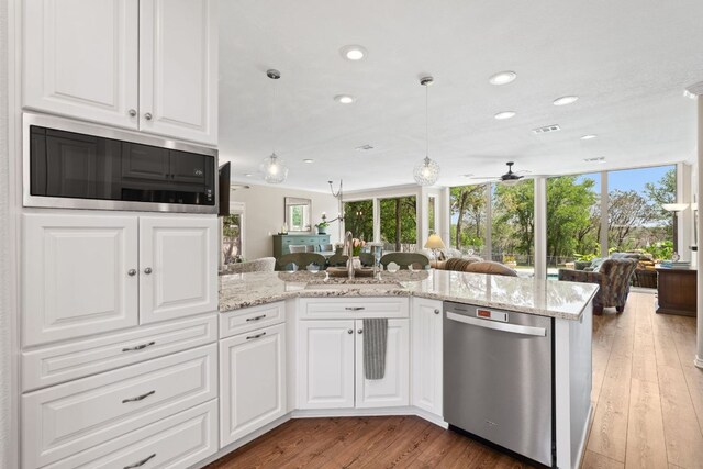 2409 Mormon Mill Rd, Marble Falls, TX 78654 - kitchen featuring open floor plan, stainless steel appliances, and a healthy amount of sunlight
